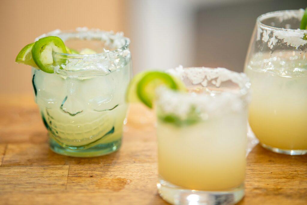 Margaritas with salt rim and lime and jalapeno garnish