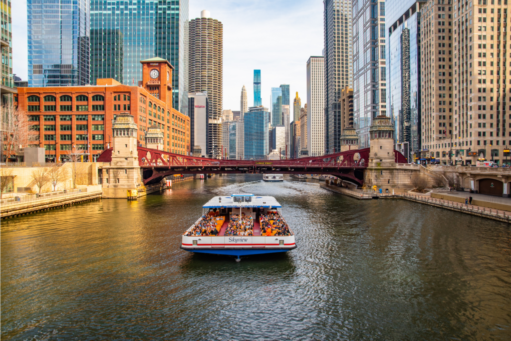 Shoreline Sightseeing boat floating under bridge